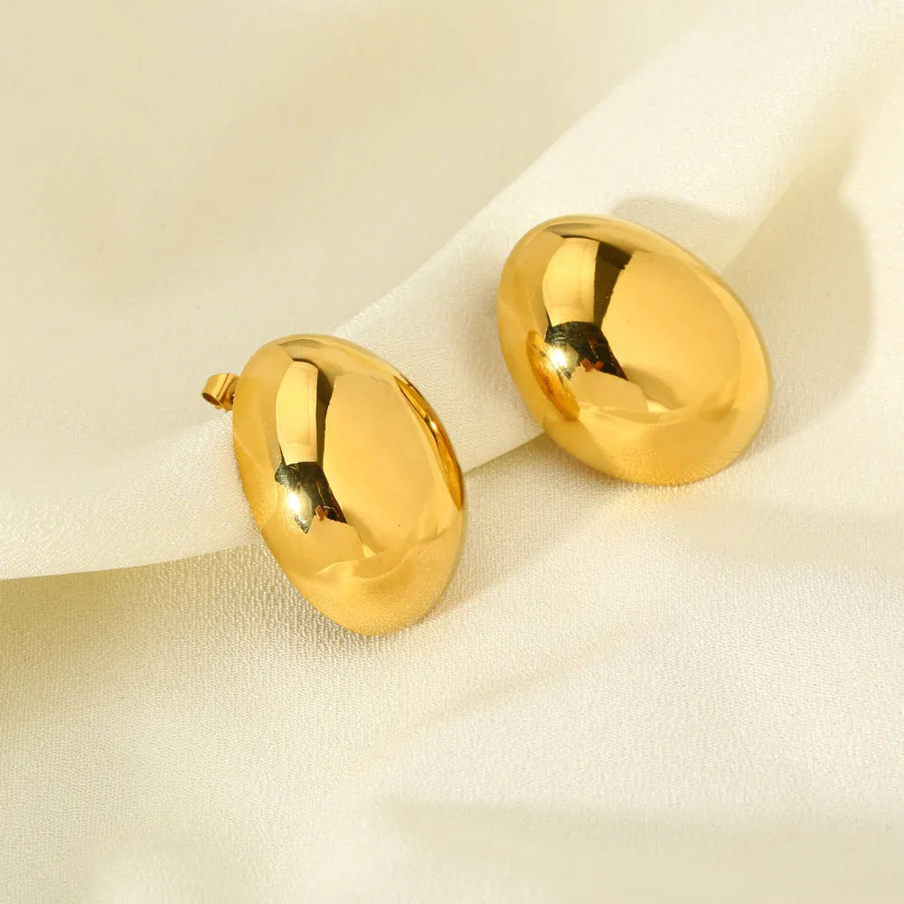 Geometric stainless steel ear studs with 18K gold plating and a glazed surface finish.