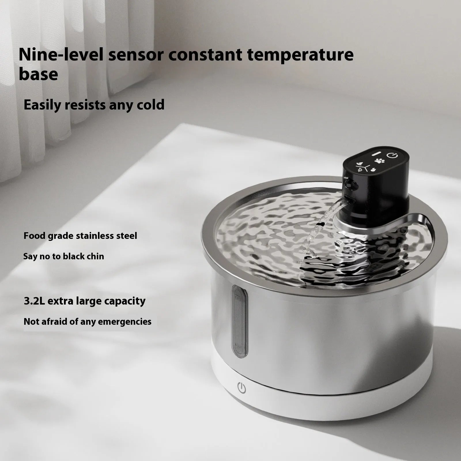 Stainless steel heated pet water fountain with white base on a kitchen floor.