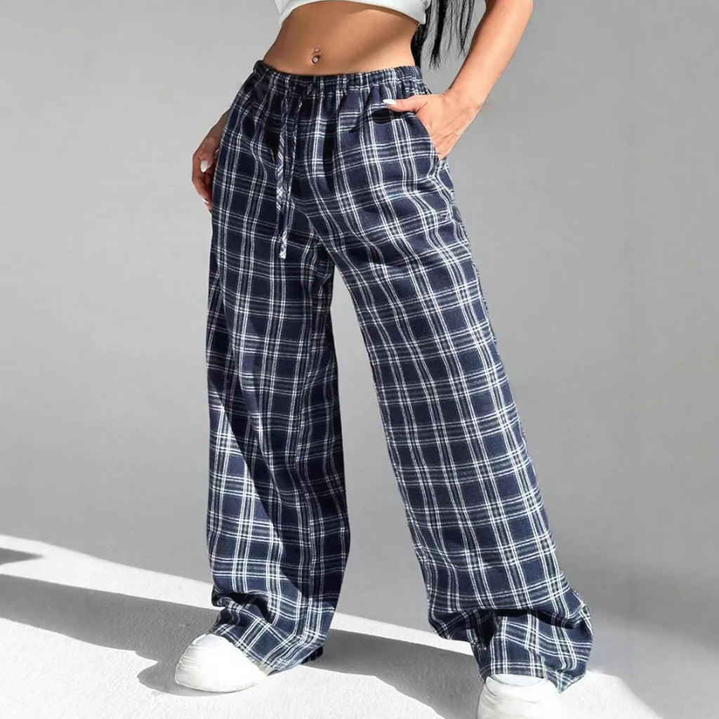 Blue women's loose fit casual trousers with a drawstring waist and front pockets on a hanger.