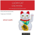 Solar-powered Maneki Neko waving cat car decoration in yellow on dashboard