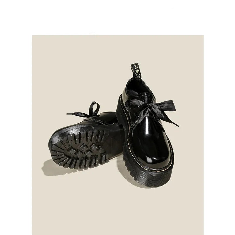 Women's white and black thick soled lace-up shoes with ribbon cross-straps on a superfine fibre upper.