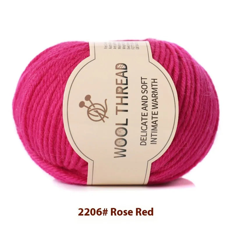 One roll of beige domestic wool hand-knitting yarn for size 10 needles next to knitting needles.