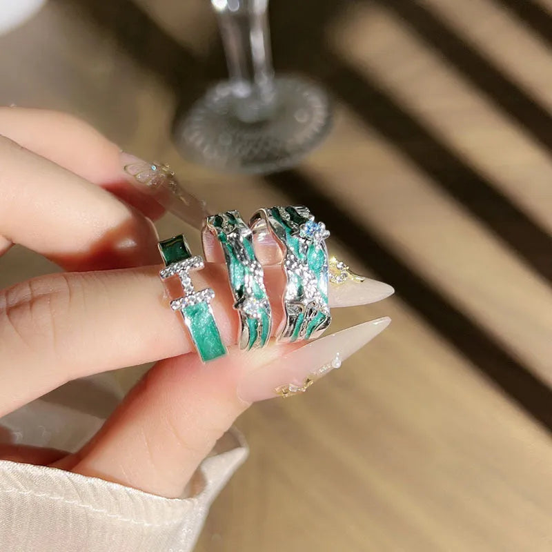 Mint green enamel asterism ring with asymmetric folded copper design and eight-point star pattern