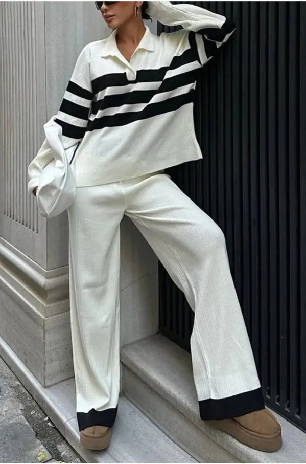 Women's black and white striped polo collar knitted top with matching trousers, a casual two-piece set.