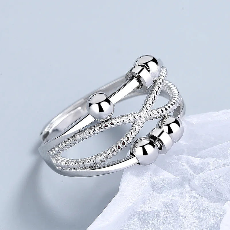 Rotatable copper ring with open design double-layered hollow line construction in platinum colour geometric shape