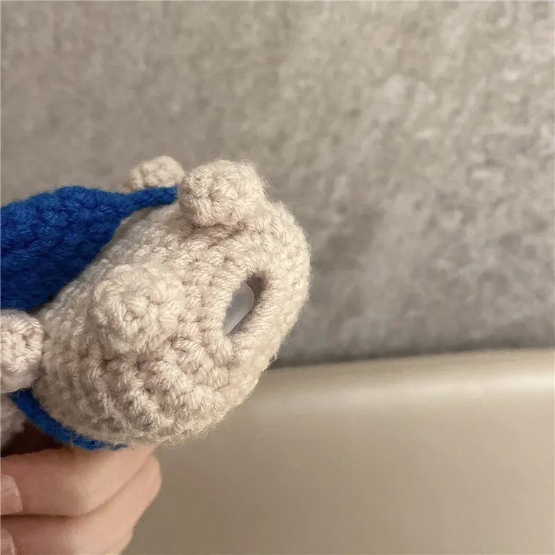 Hand-knitted grey koala bear design cover on a white Airpods case.