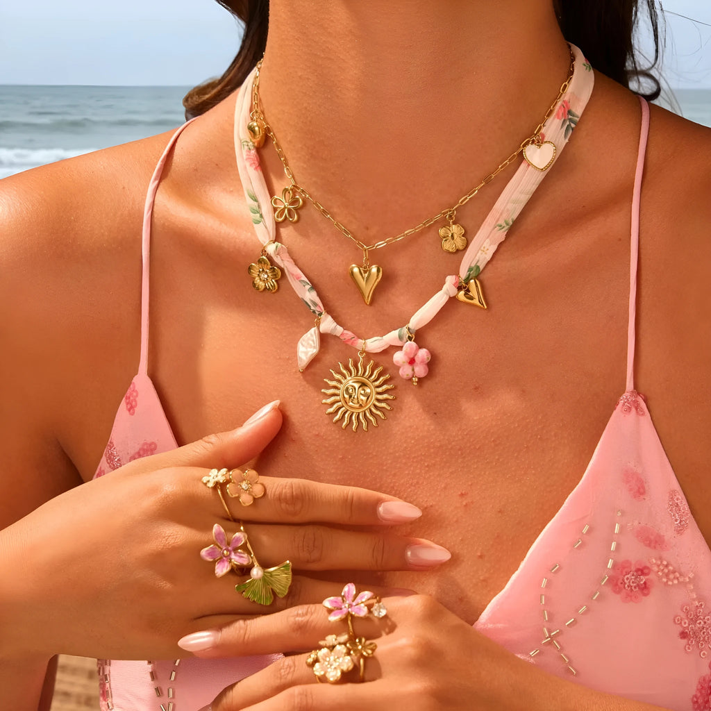 Sun Love pendant necklace in stainless steel with 18K electroplate, showing Heart and Ribbon Sun design options.