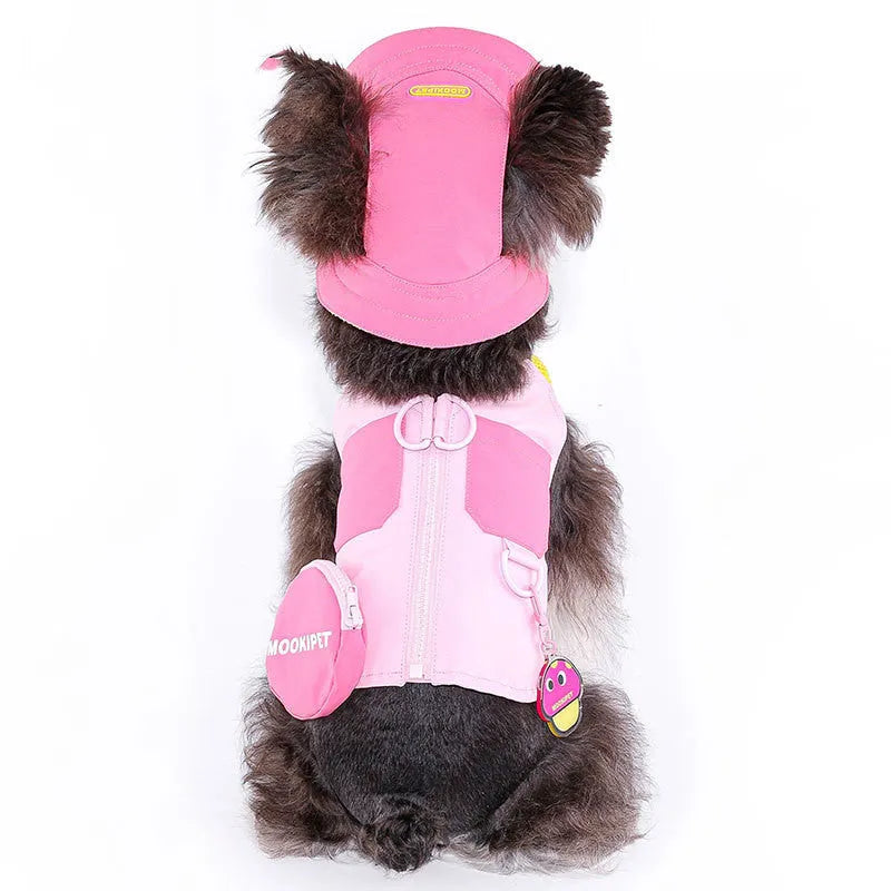 Pink polyester traction vest for small dogs on a Bichon Frisé, showing casual style and lead attachment point.