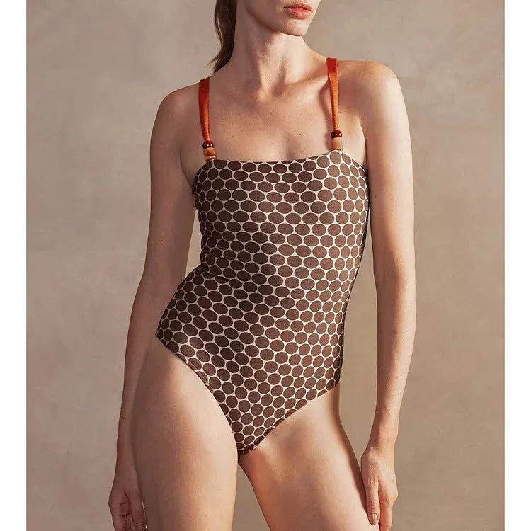Women's printed dot one-piece swimsuit with a matching wrap skirt, shown on a mannequin.