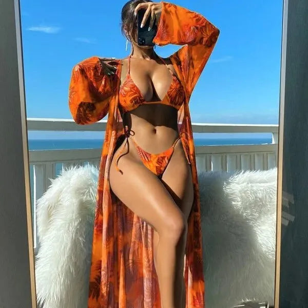 Women's long sleeve bikini swimsuit set with banded briefs and a matching robe in blue.
