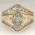 Geometric gold-coloured palace style fashion ring on a plain background, showing its angular design.