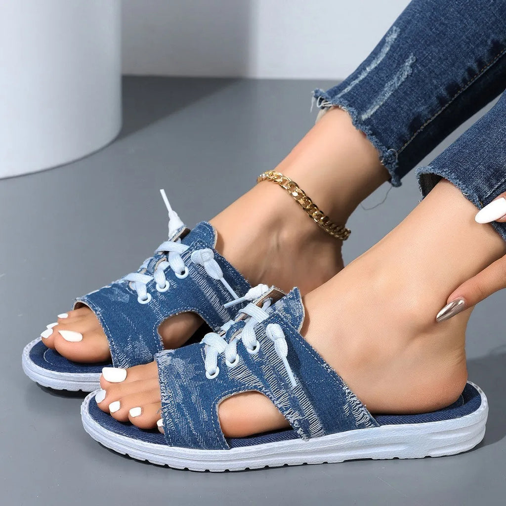 Blue Roman-style canvas slippers with cloth lining and rubber sole showing flat design