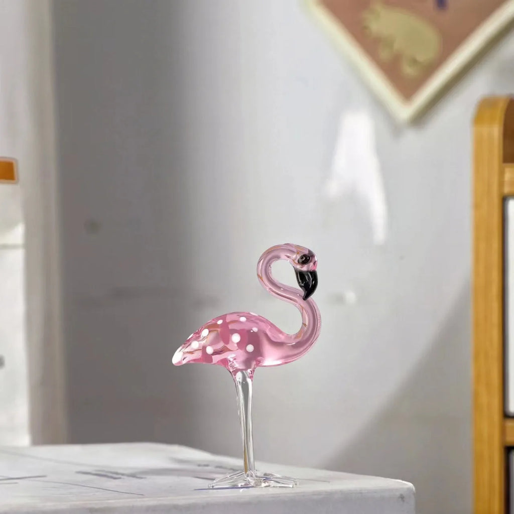 Pink crystal flamingo decorative ornament on a table for modern home decor.