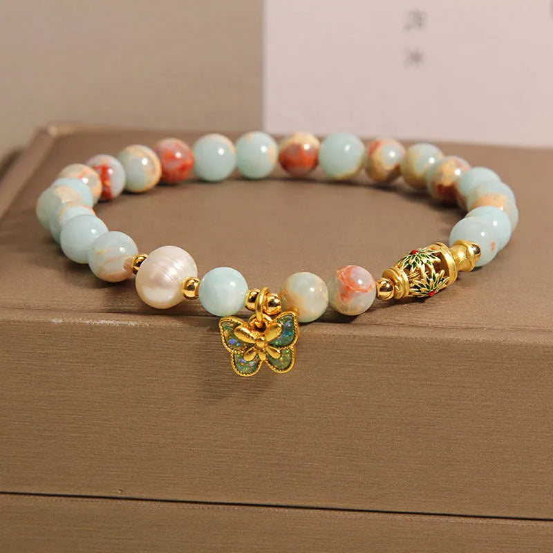Blue women's bracelet with Shoushan stone, freshwater pearls and butterfly charm pendant