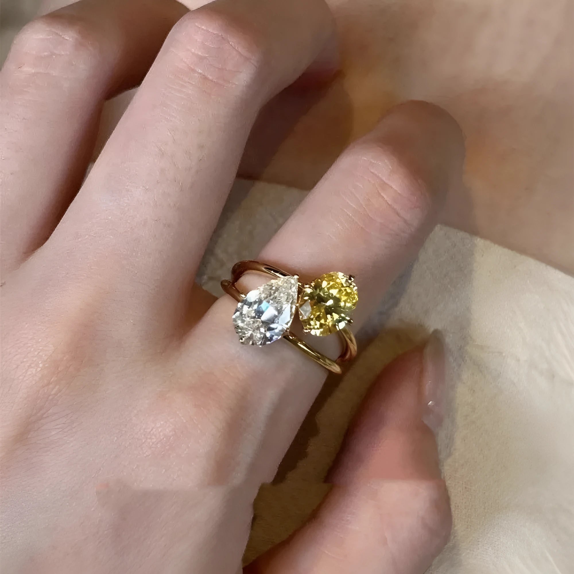 Geometric copper open ring with a double-tiered blue synthetic zircon stone in a water drop shape, showing polished and brushed contrast finishes.