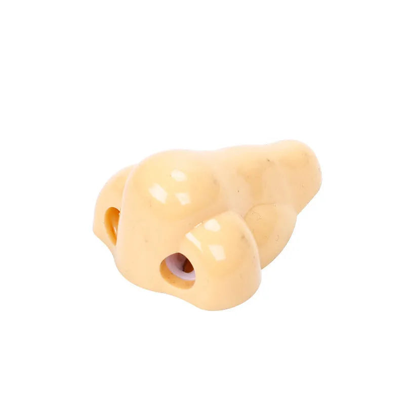Flesh-coloured plastic manual pencil sharpener with a geometry shape and large nostril.