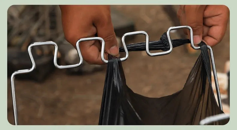Stainless steel folding garbage bag bracket in collapsed position showing silver finish
