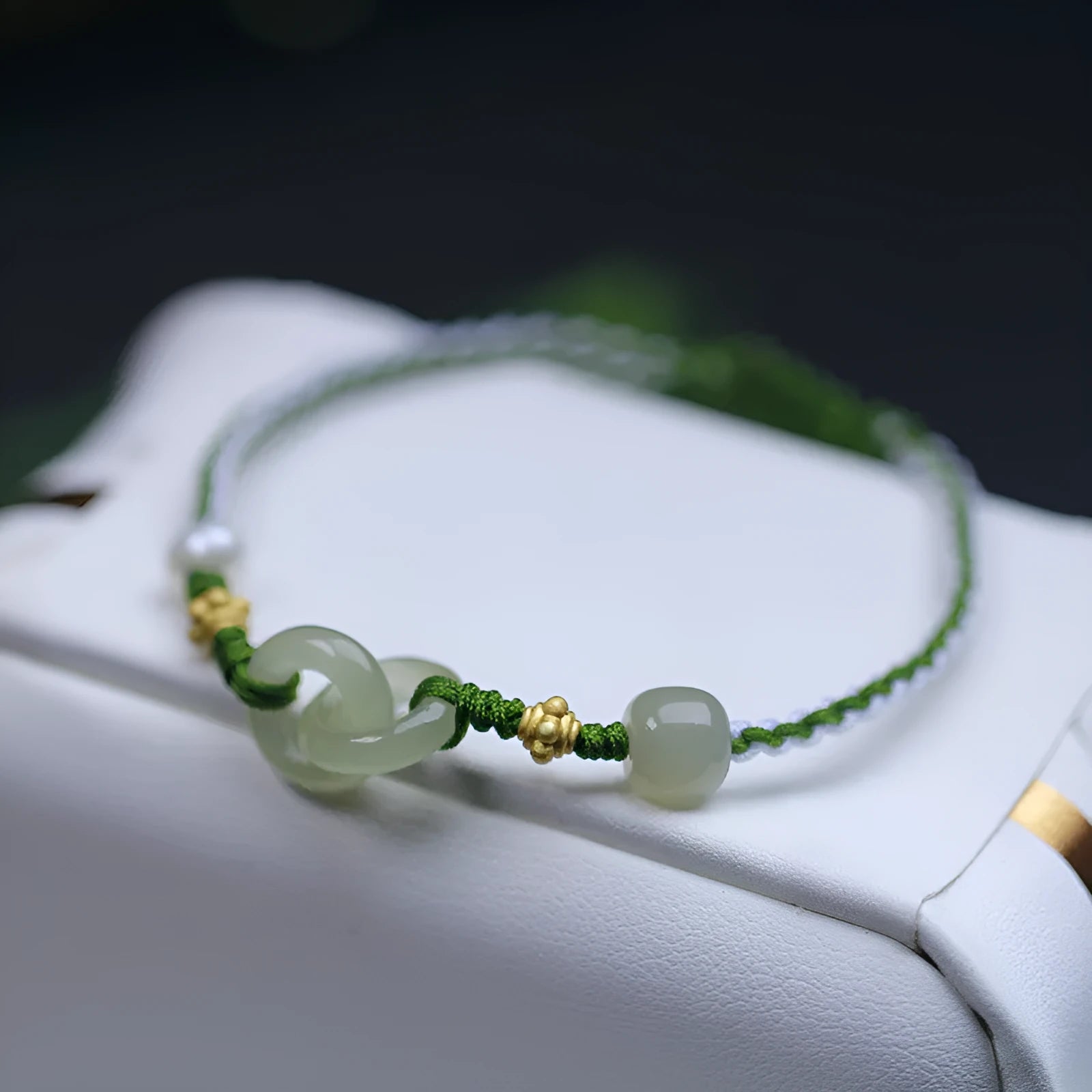Natural Hetian jade pendant on woven wire bracelet with hollow-out design