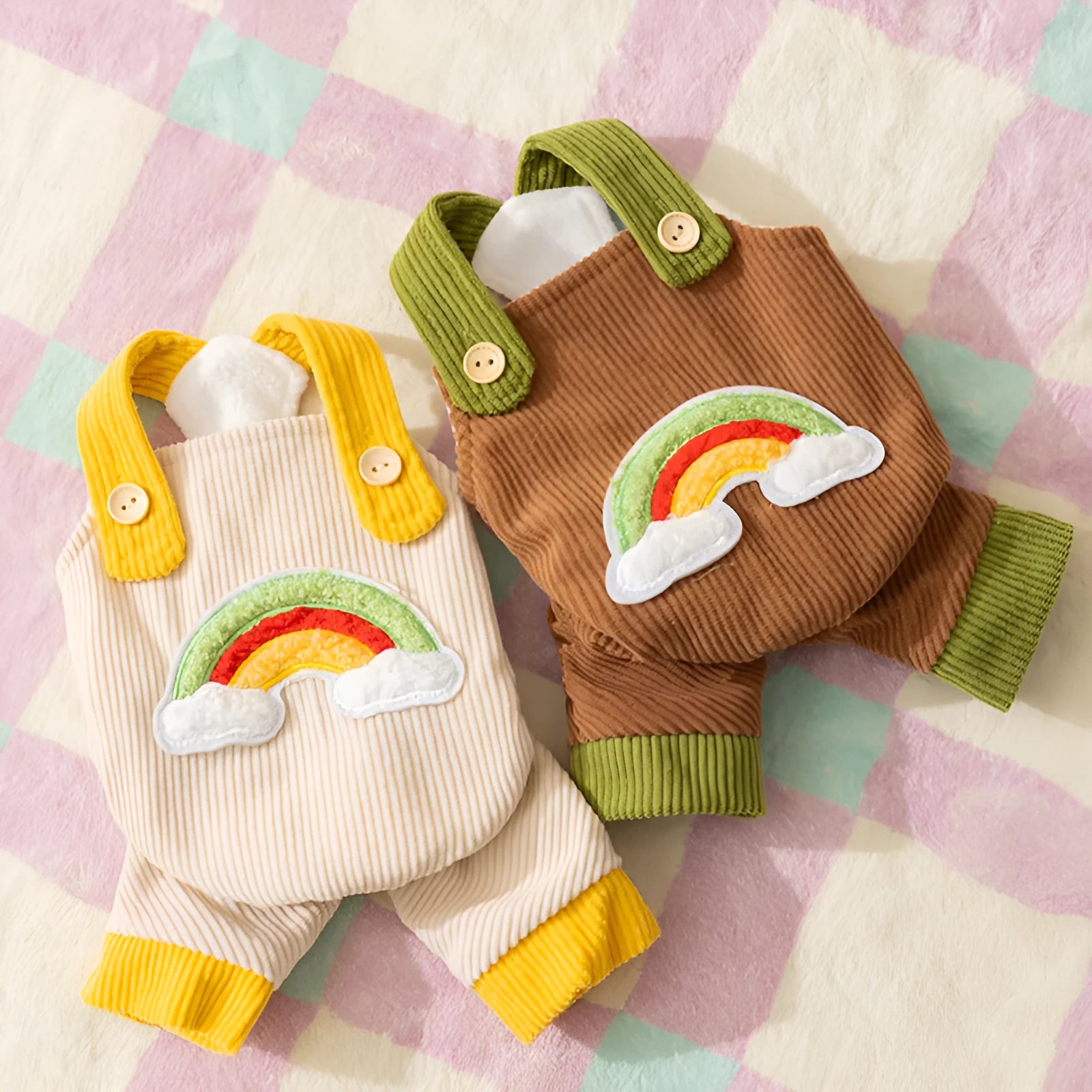 Small dog wearing beige corduroy overalls with rainbow print, autumn winter outfit
