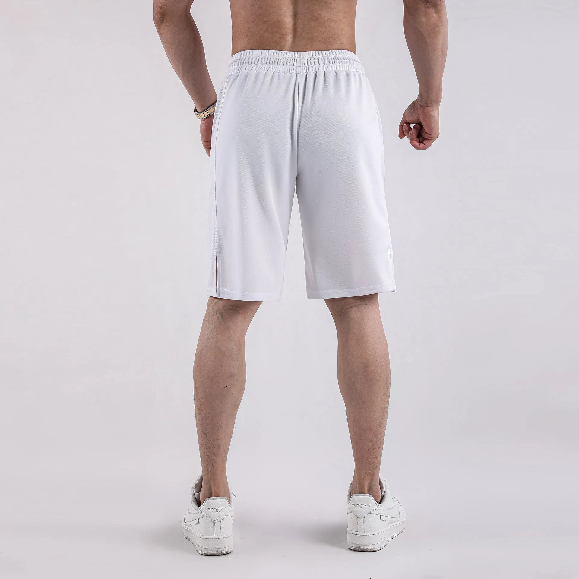 Man wearing black quick-drying mesh fitness shorts with elastic waistband