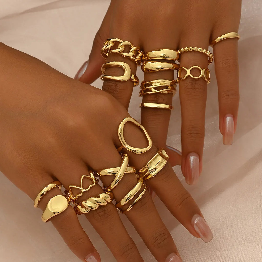 Women's 16-piece open ring suit in silver and gold zinc alloy geometric shape on display