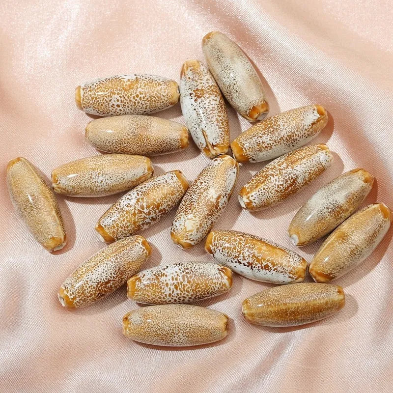 Assorted high-temperature fired ceramic bullet beads in pink, yellow, blue, red, coffee, green, orange, and mixed glaze colours.