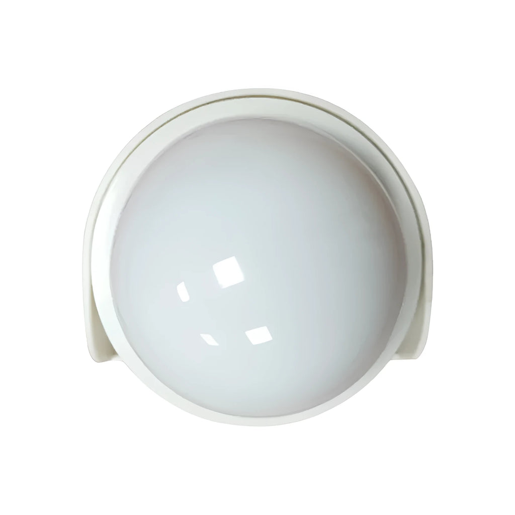 Compact colourful gradient 3D shooting night light with remote control on a desk.