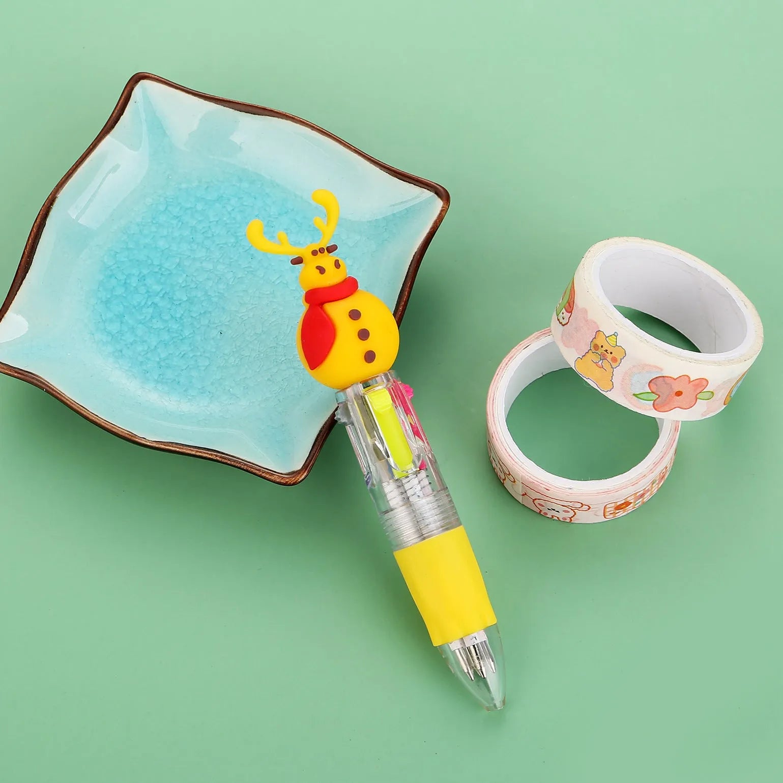 Compact 11cm Christmas ballpoint pen with four colours and festive designs like snowmen and reindeer.