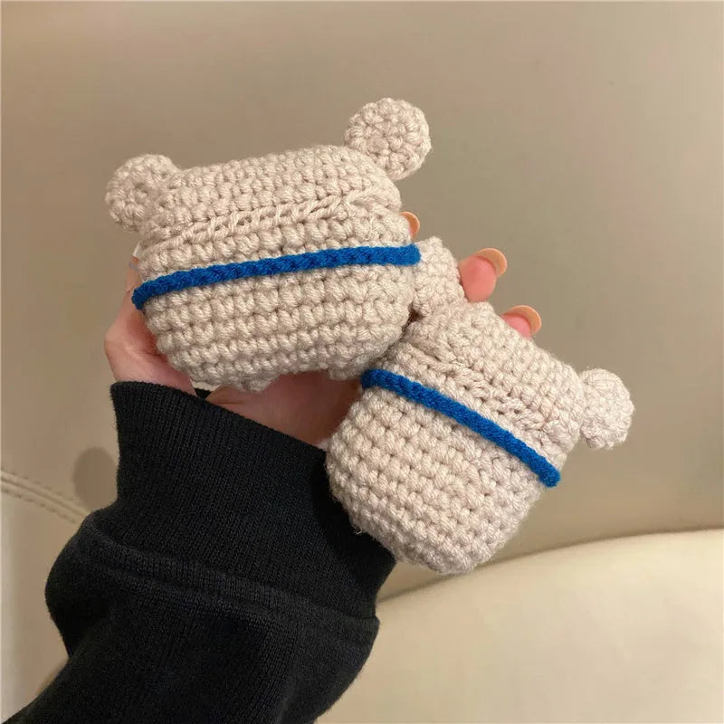 Hand-knitted grey koala bear design cover on a white Airpods case.