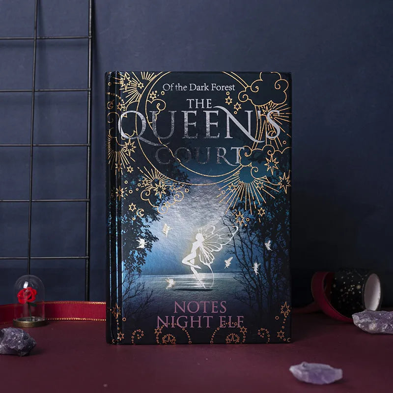 Blue and purple luminous hardcover A5 notebooks open to show full-colour illustrated pages