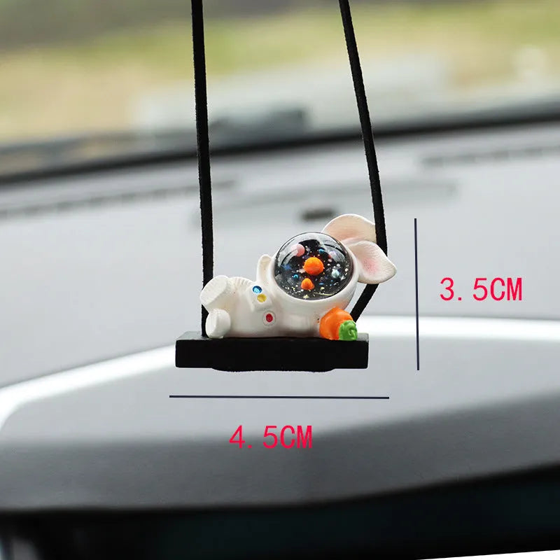 Cartoon style resin astronaut car pendant in five different colour and design variants.