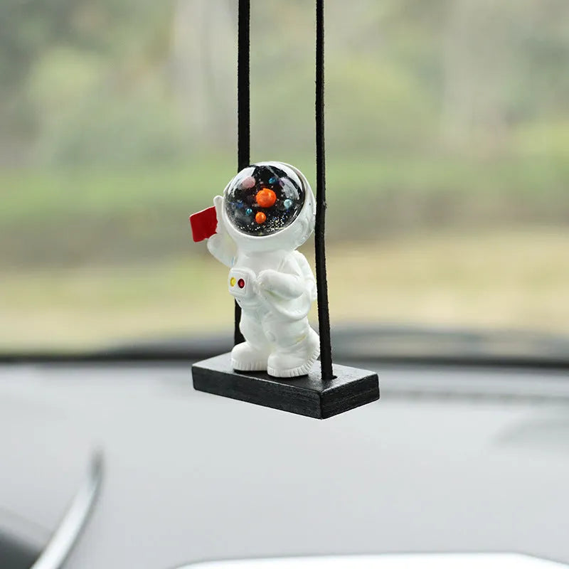 Cartoon style resin astronaut car pendant in five different colour and design variants.