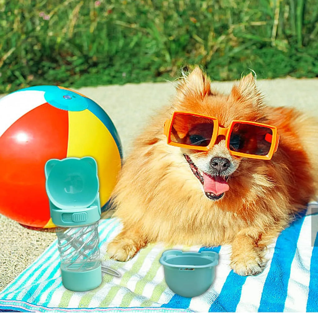 Green 3-in-1 portable pet water bottle with bowl, food container, and bag dispenser attached to a strap.