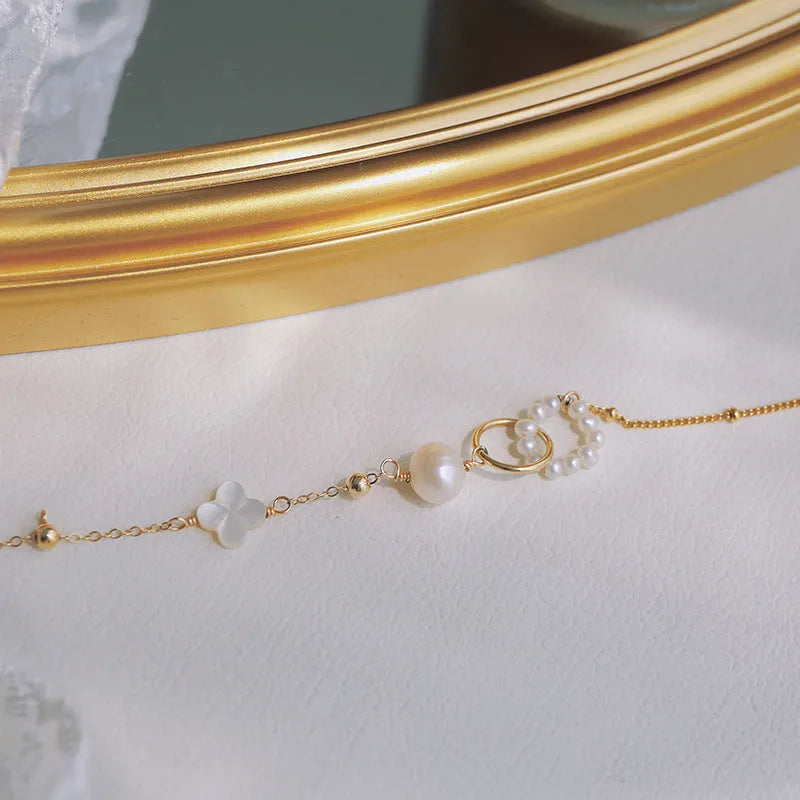 Natural pearl women's bracelet with a 14k gold-plated setting on a single strand.