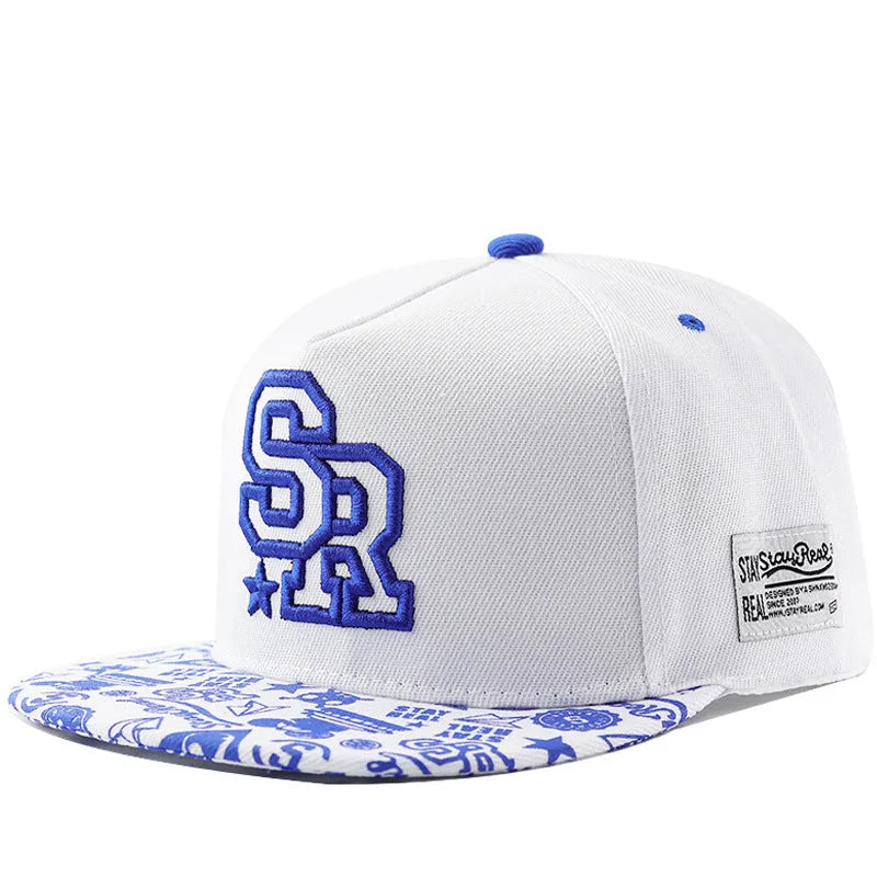 White cotton baseball cap with embroidered lettering on the front, showing the adjustable strap at the back.