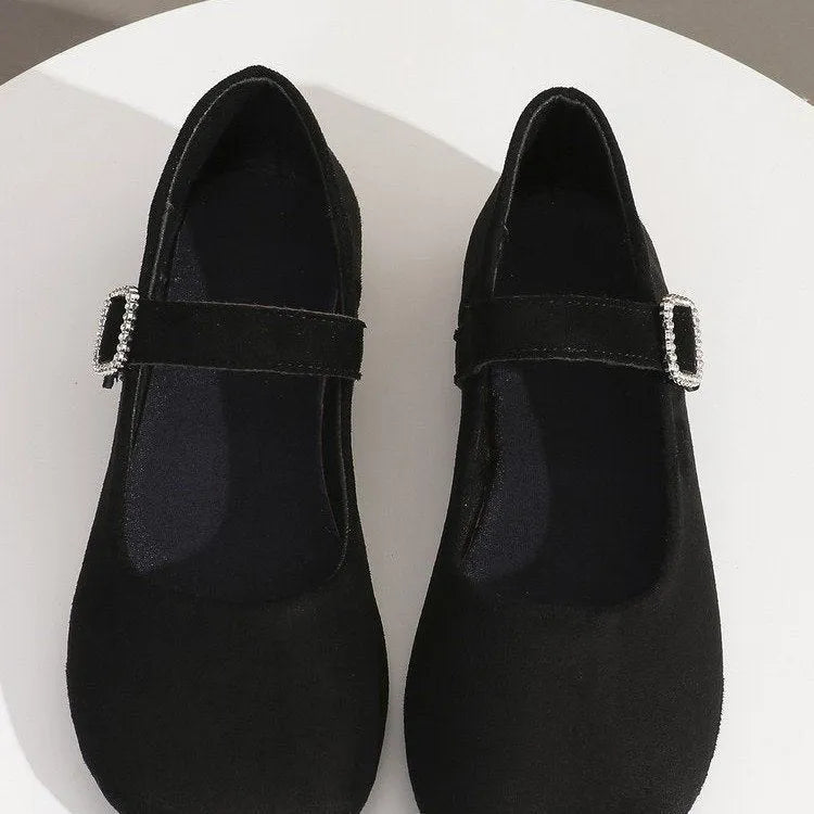 A pair of black men's canvas fisherman flat shoes with a rubber sole on a white background.