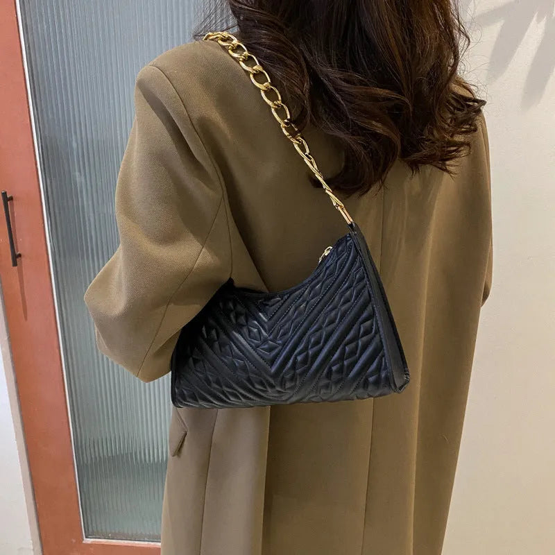 Brown vertical PU leather shoulder bag with a silver pleated chain strap and a soft handle.