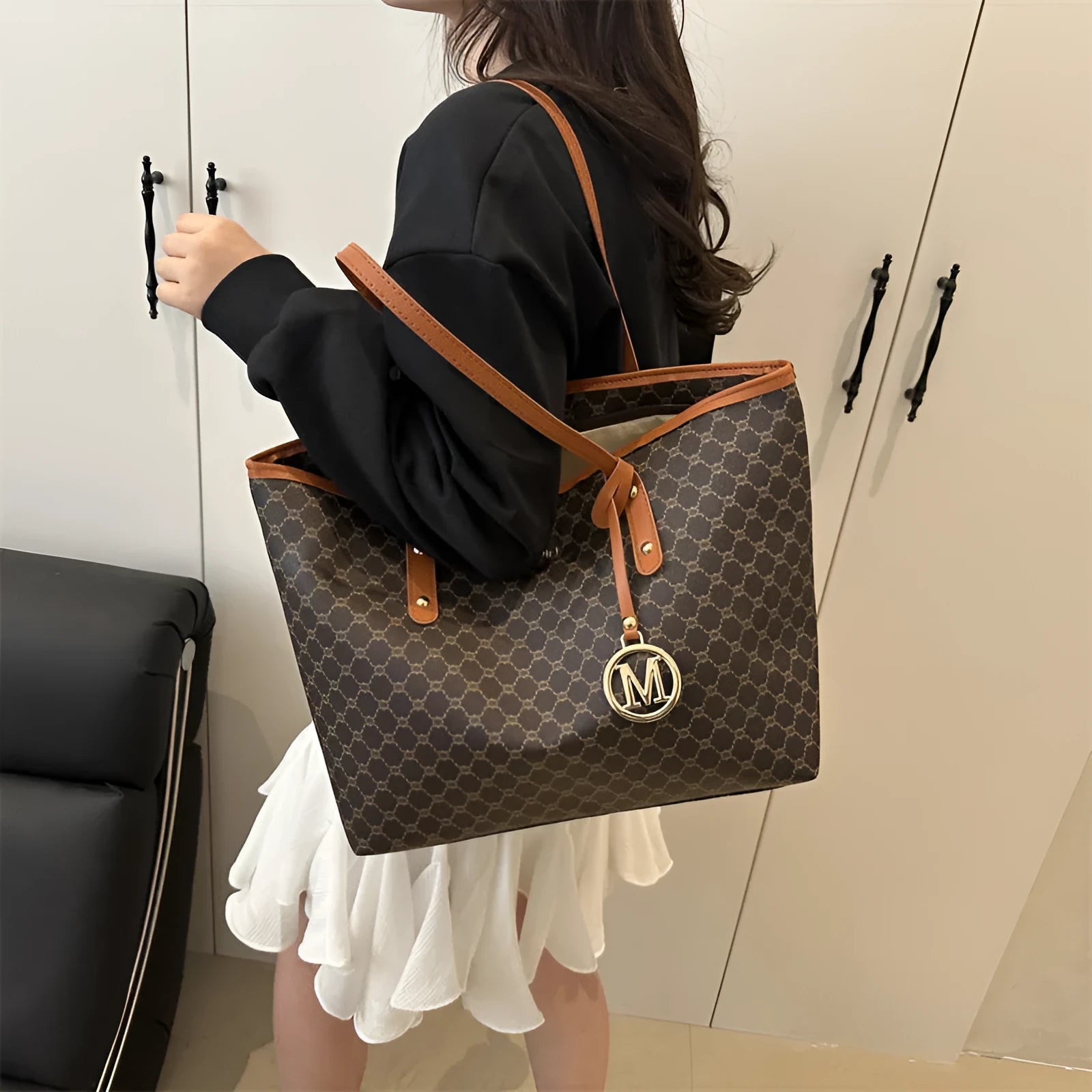 Large black PU leather shoulder bag with sewn thread detailing on a white background.