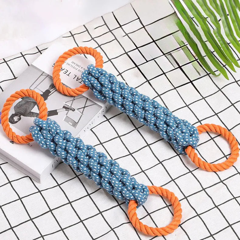 Blue braided cotton rope dog toy shaped like a bone with two rings, on a white background.