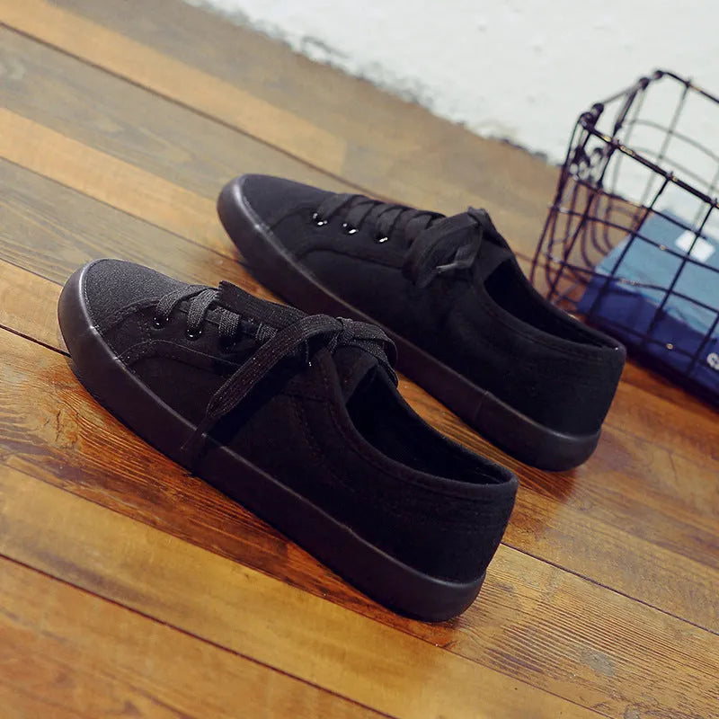 All black Korean-style women's canvas flat shoes with lace-up front and rubber sole