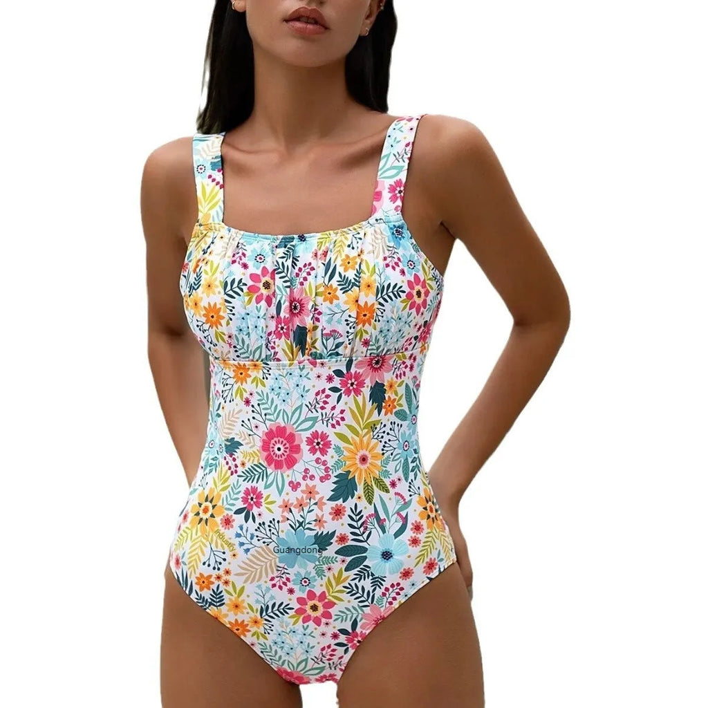 Women's black and floral print one-piece swimsuit with full coverage on a mannequin.