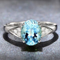 A women's sterling silver ring with a geometric pattern of inlaid red and blue natural zircon stones on a comfort-fit band.
