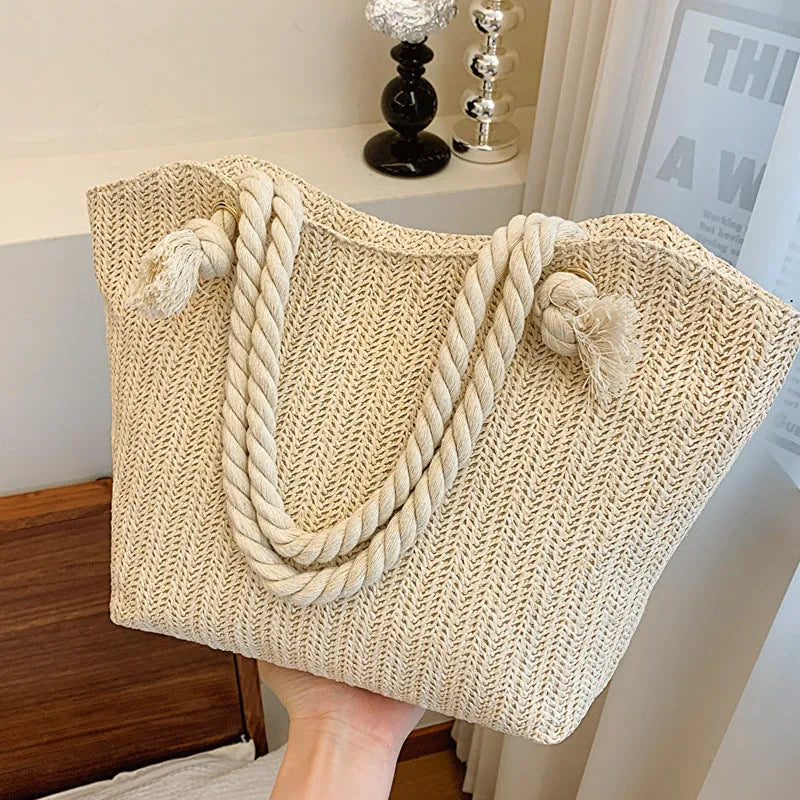 Women's straw shoulder handbag in white or khaki with clamshell opening, single strap, and phone bag