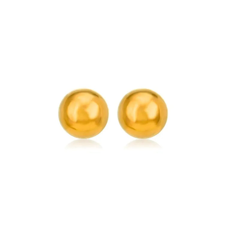 Close-up of a simple gold ball stud earring on a titanium steel post against a plain background.