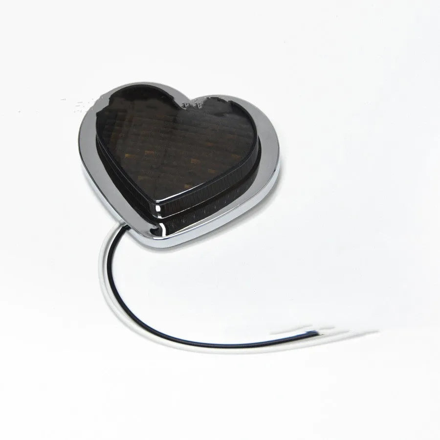 Heart-shaped red LED automotive sidelight mounted on car fender