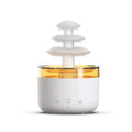 White Cloud Rain air humidifier and essential oil diffuser with colourful LED light on a table.