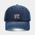 Adjustable denim peaked cap with a dome crown and a large English letter design on the front.