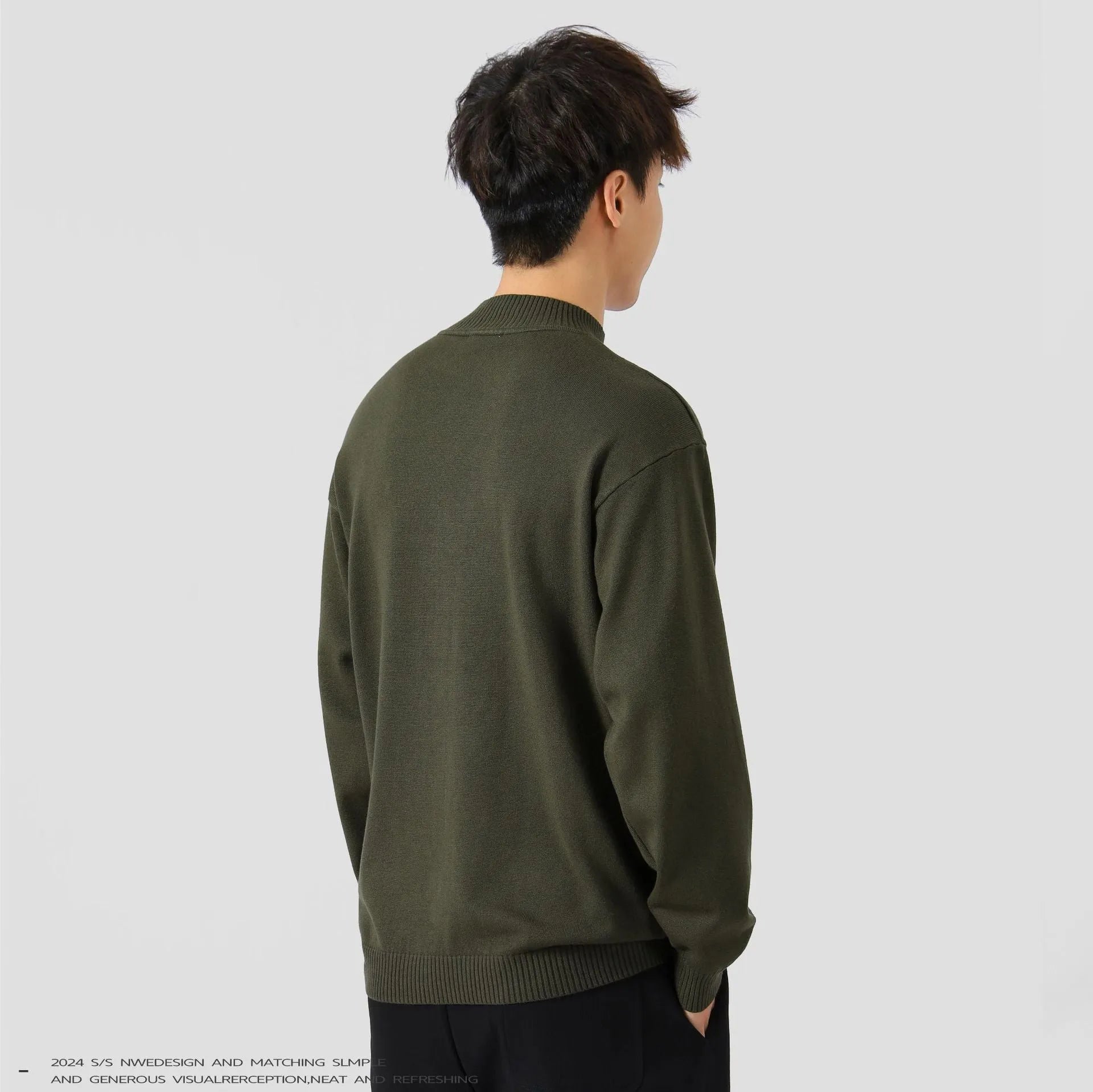 Man wearing a loose-fit army green long-sleeved pullover sweater for casual wear.