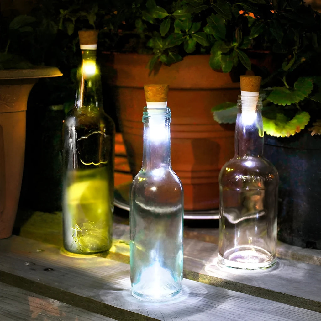 White plastic rechargeable LED bottle cap light with 15 small LEDs, shown next to a wine bottle for scale.