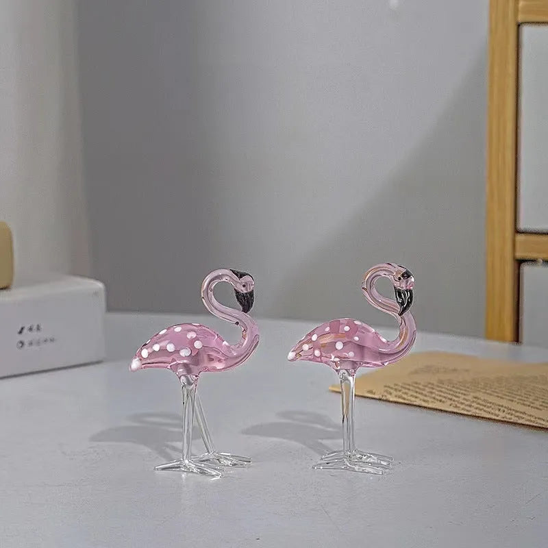 Pink crystal flamingo decorative ornament on a table for modern home decor.